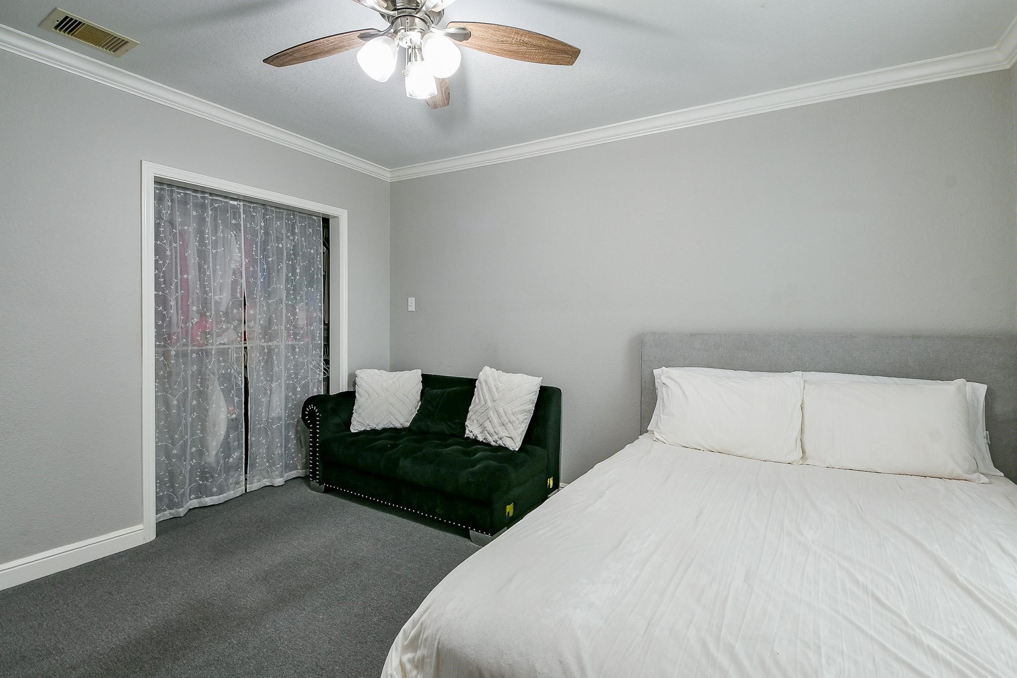 910 11th Street South Houston, TX 77587 - Photo 24 of 32 a spacious bedroom with a bed and a chandelier