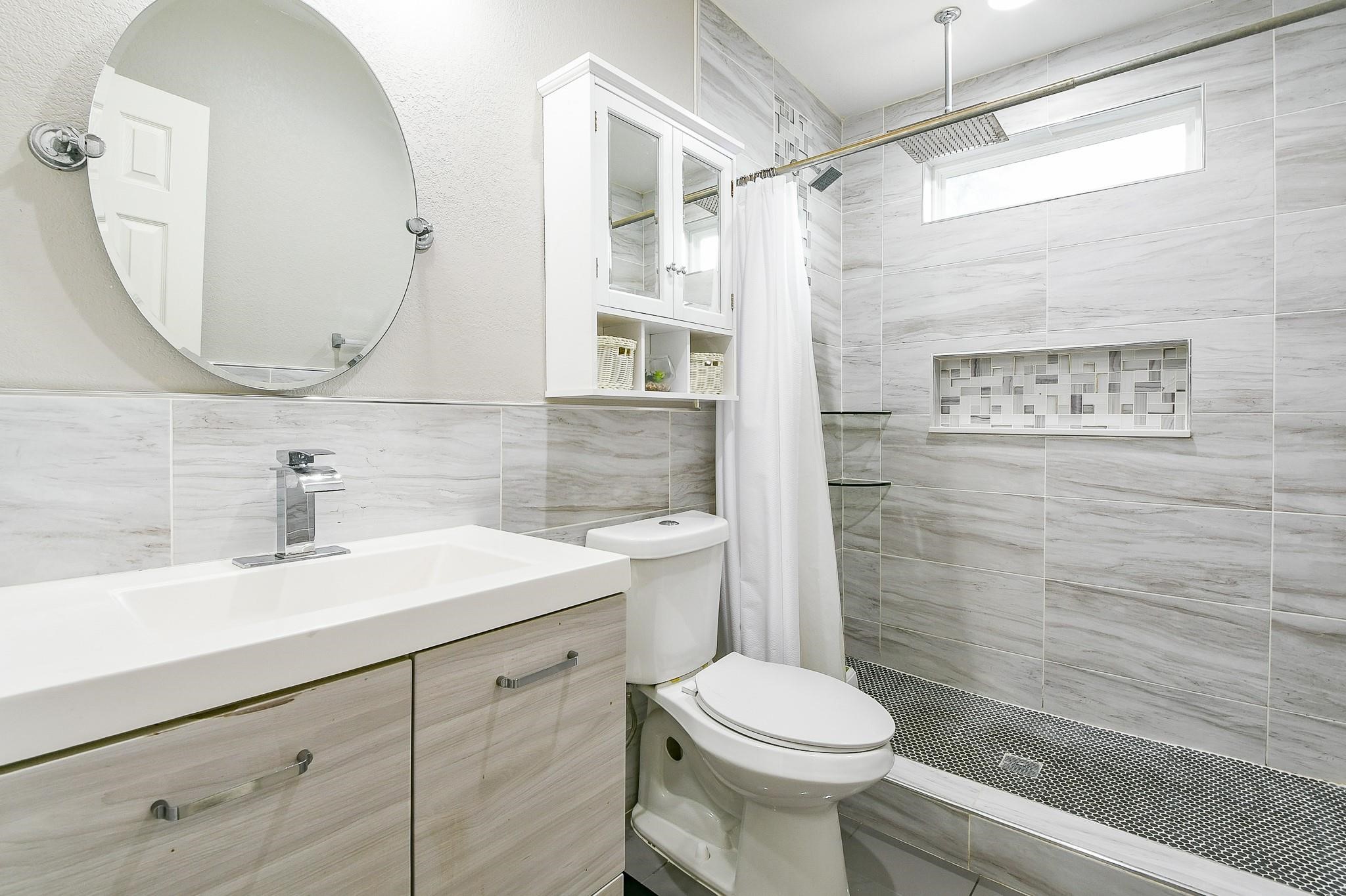 910 11th Street South Houston, TX 77587 - Photo 27 of 32 a bathroom with a sink a toilet and shower