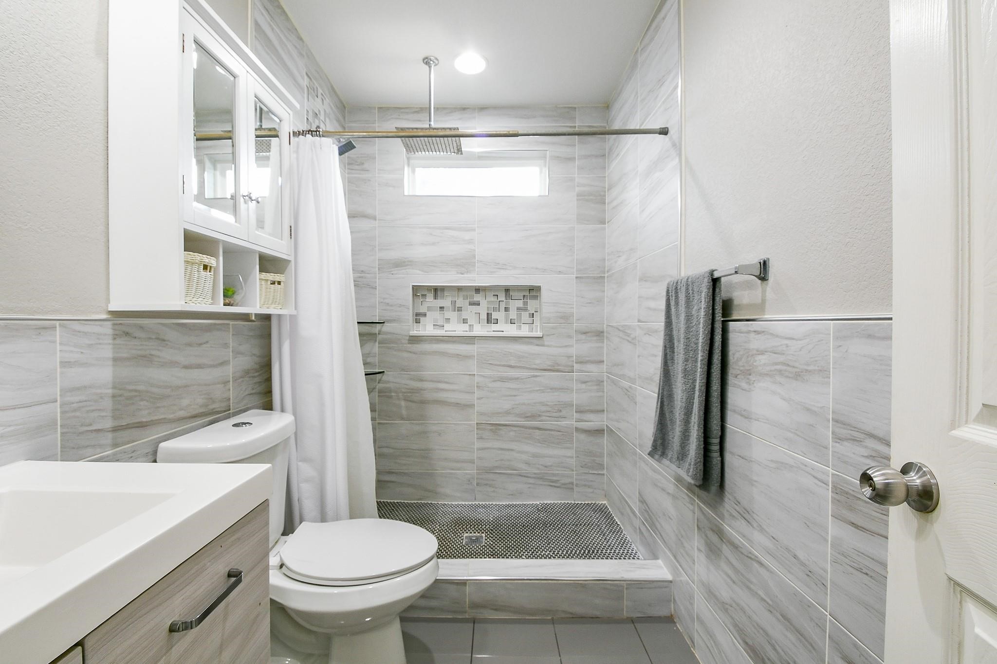 910 11th Street South Houston, TX 77587 - Photo 28 of 32 a bathroom with a shower and a toilet