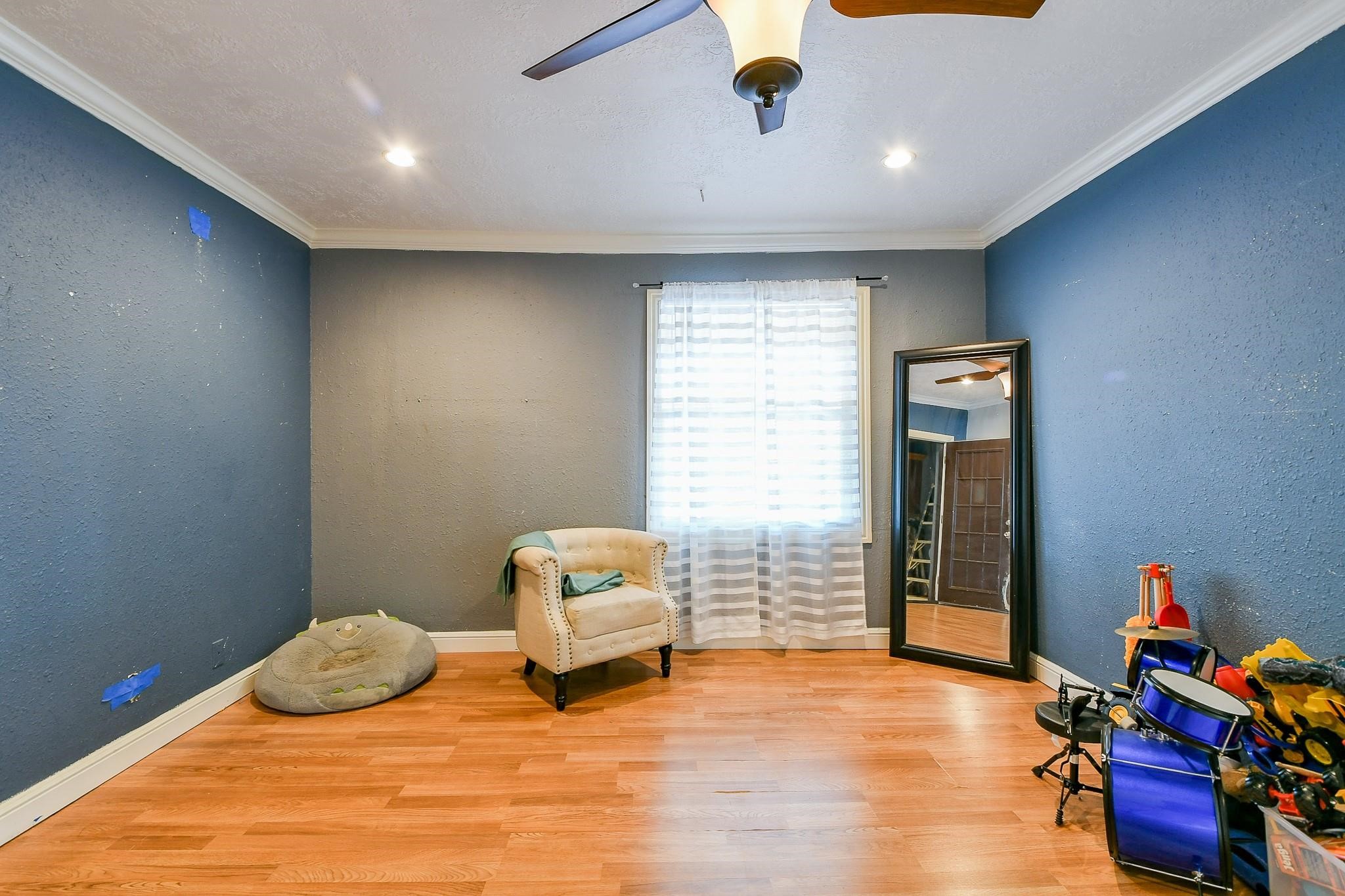 910 11th Street South Houston, TX 77587 - Photo 30 of 32 a bedroom with furniture and a wooden floor