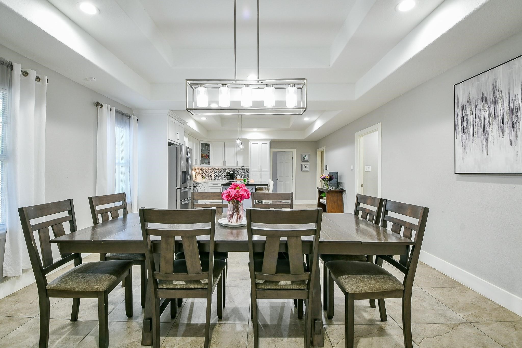 910 11th Street South Houston, TX 77587 - Photo 5 of 32 a view of a dining room with furniture and chandelier