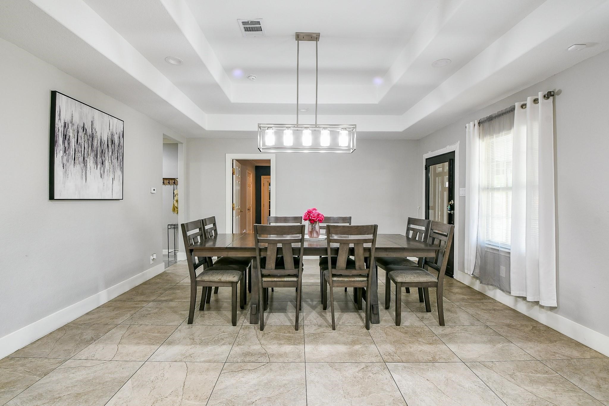 910 11th Street South Houston, TX 77587 - Photo 7 of 32 a view of a dining room with furniture and a chandelier