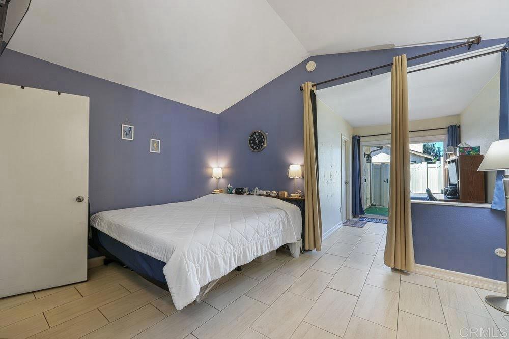 10385 Seth Way Santee, CA 92071 - Photo 17 of 33 a bed sitting in a spacious bedroom next to a window