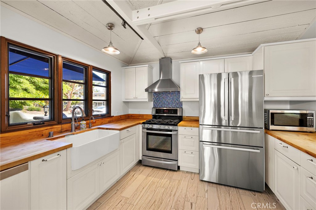 490 Agate Street Laguna Beach, CA 92651 - Photo 16 of 38 a kitchen with granite countertop stainless steel appliances a sink and a window