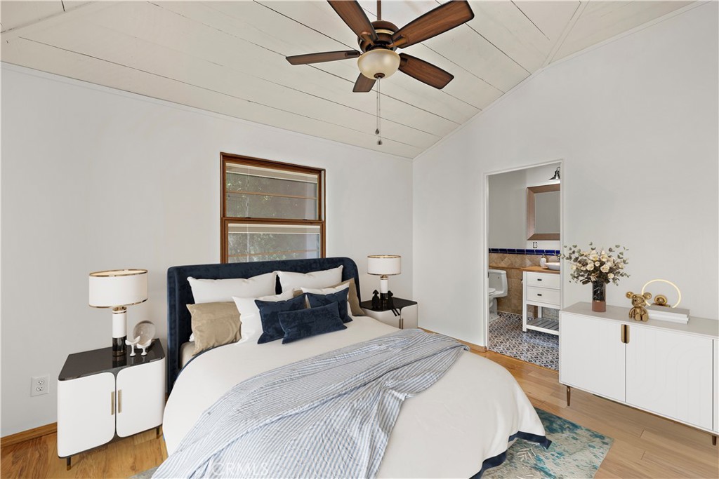 490 Agate Street Laguna Beach, CA 92651 - Photo 19 of 38 a bedroom with a bed and a chandelier