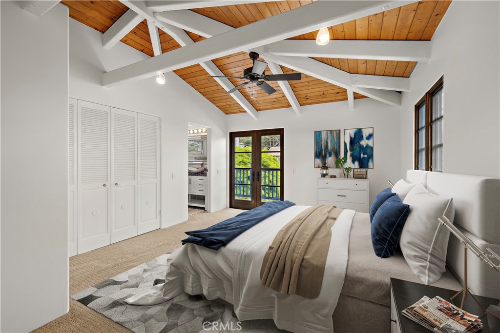 490 Agate Street Laguna Beach, CA 92651 - Photo 24 of 38 a bedroom with a bed and a large mirror with the outer view