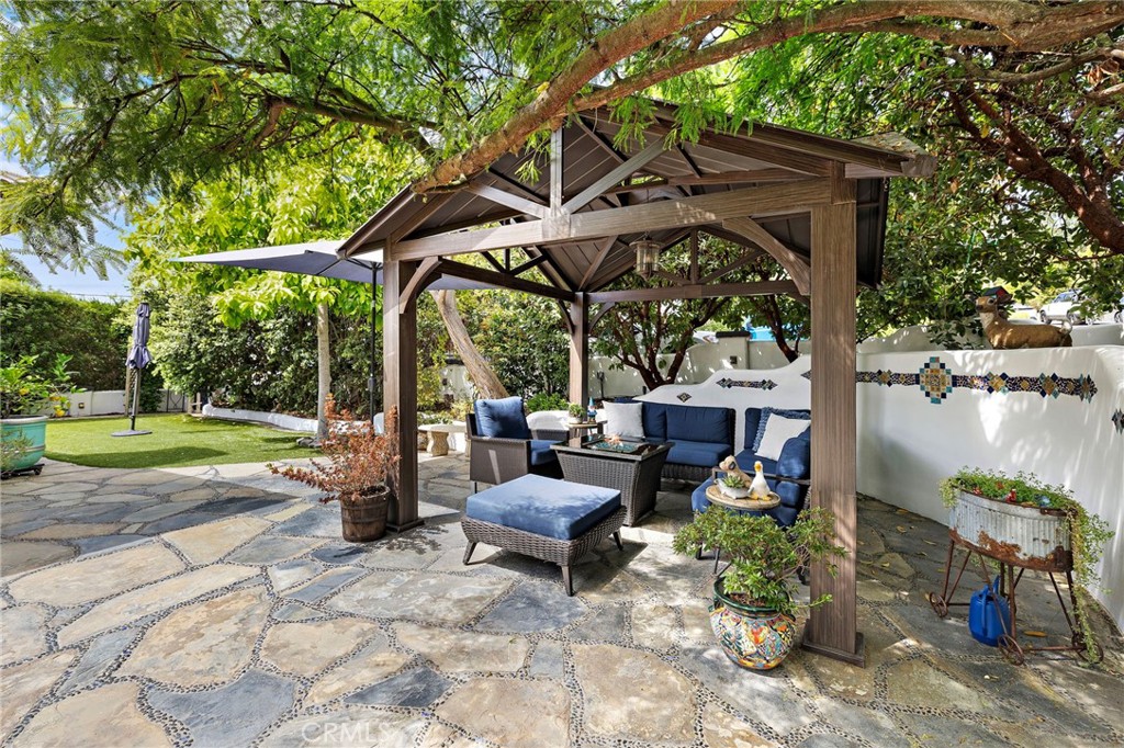 490 Agate Street Laguna Beach, CA 92651 - Photo 5 of 38 a view of a patio with table and chairs under an umbrella
