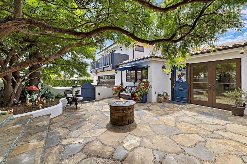490 Agate Street Laguna Beach, CA 92651 - Photo 6 of 38 a view of a chair and tables in the patio and a fountain