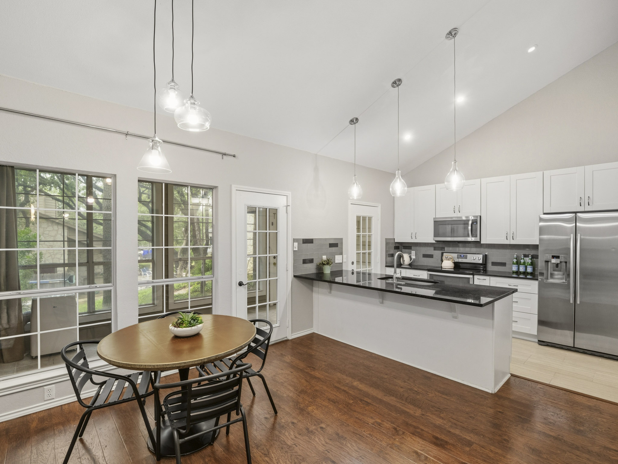 3809 Spicewood Springs Road, Unit 137 Austin, TX 78759 - Photo 5 of 34 Sleek kitchen with a breakfast bar seamlessly connecting to a luminous dining space.