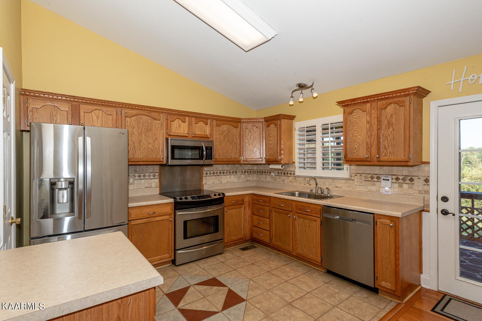 1010 Burton Road Greenback, TN 37742 - Photo 9 of 49 a kitchen with stainless steel appliances granite countertop a sink stove and refrigerator