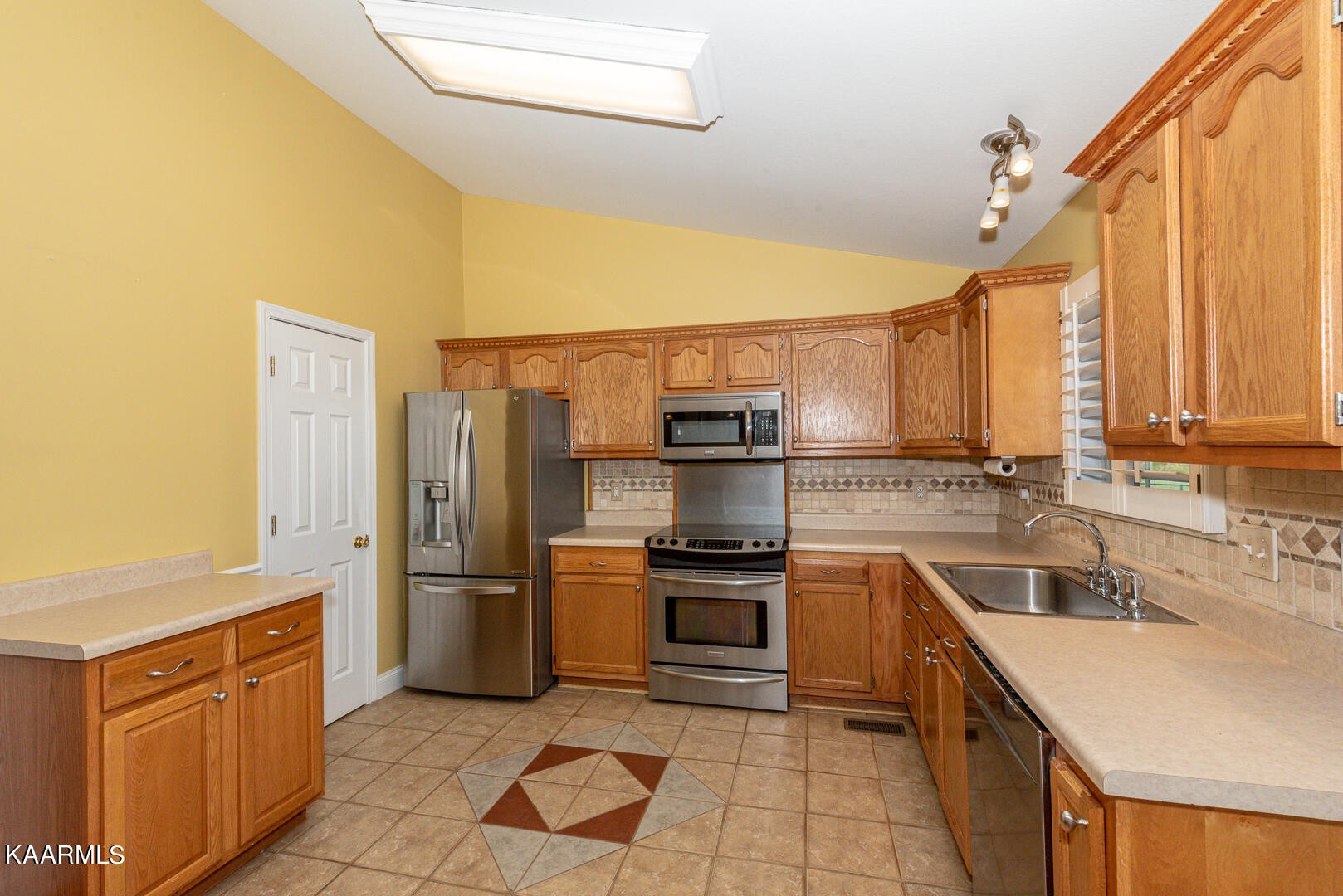 1010 Burton Road Greenback, TN 37742 - Photo 10 of 49 a kitchen with kitchen island granite countertop a sink counter top space appliances and cabinets