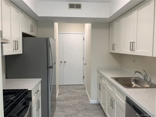 a kitchen with a sink stove and refrigerator