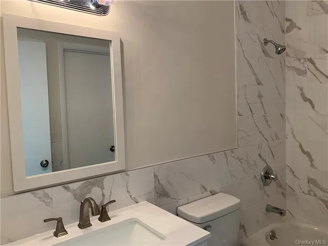 a bathroom with a toilet and a sink