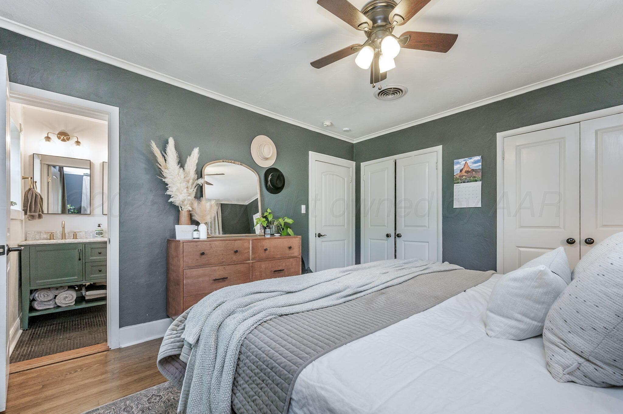 501 Sunset Terrace Amarillo, TX 79106 - Photo 11 of 21 a bedroom with a bed and a chandelier