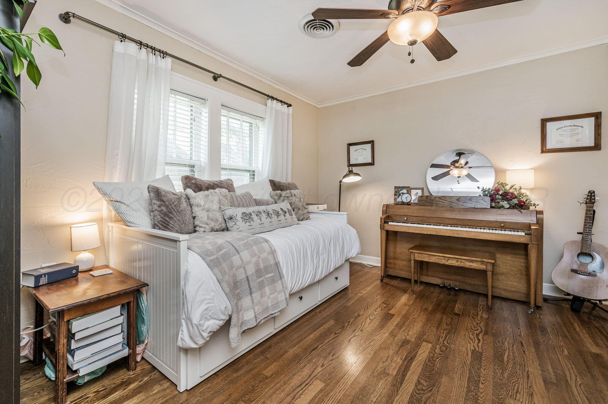 501 Sunset Terrace Amarillo, TX 79106 - Photo 17 of 21 a bedroom with a bed and a chandelier