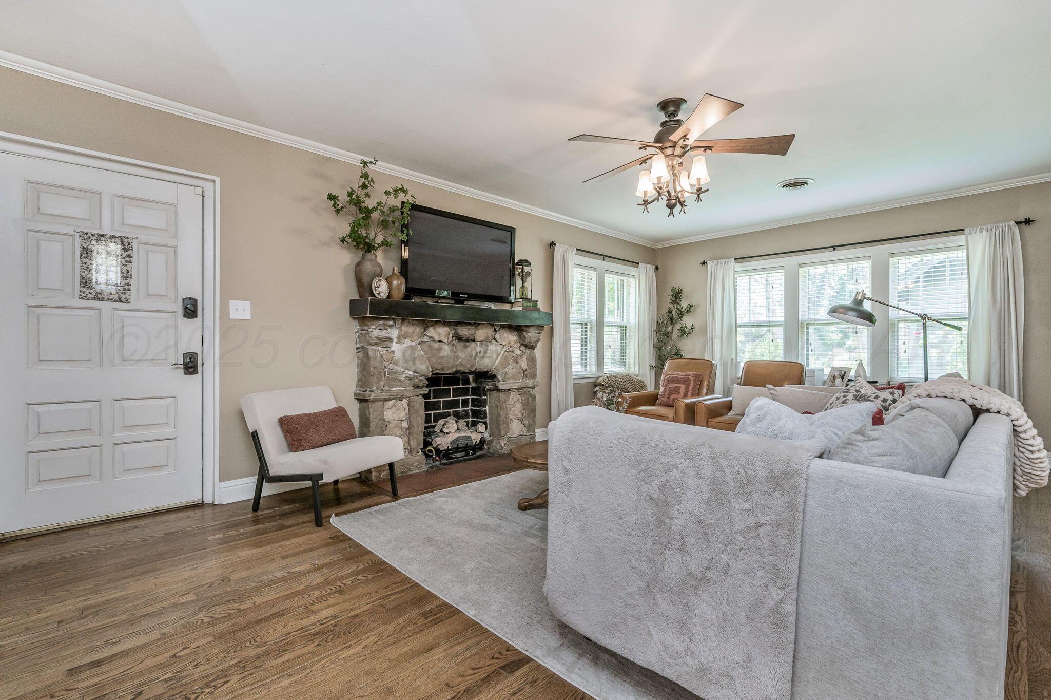 501 Sunset Terrace Amarillo, TX 79106 - Photo 4 of 21 a living room with furniture a fireplace and a flat screen tv
