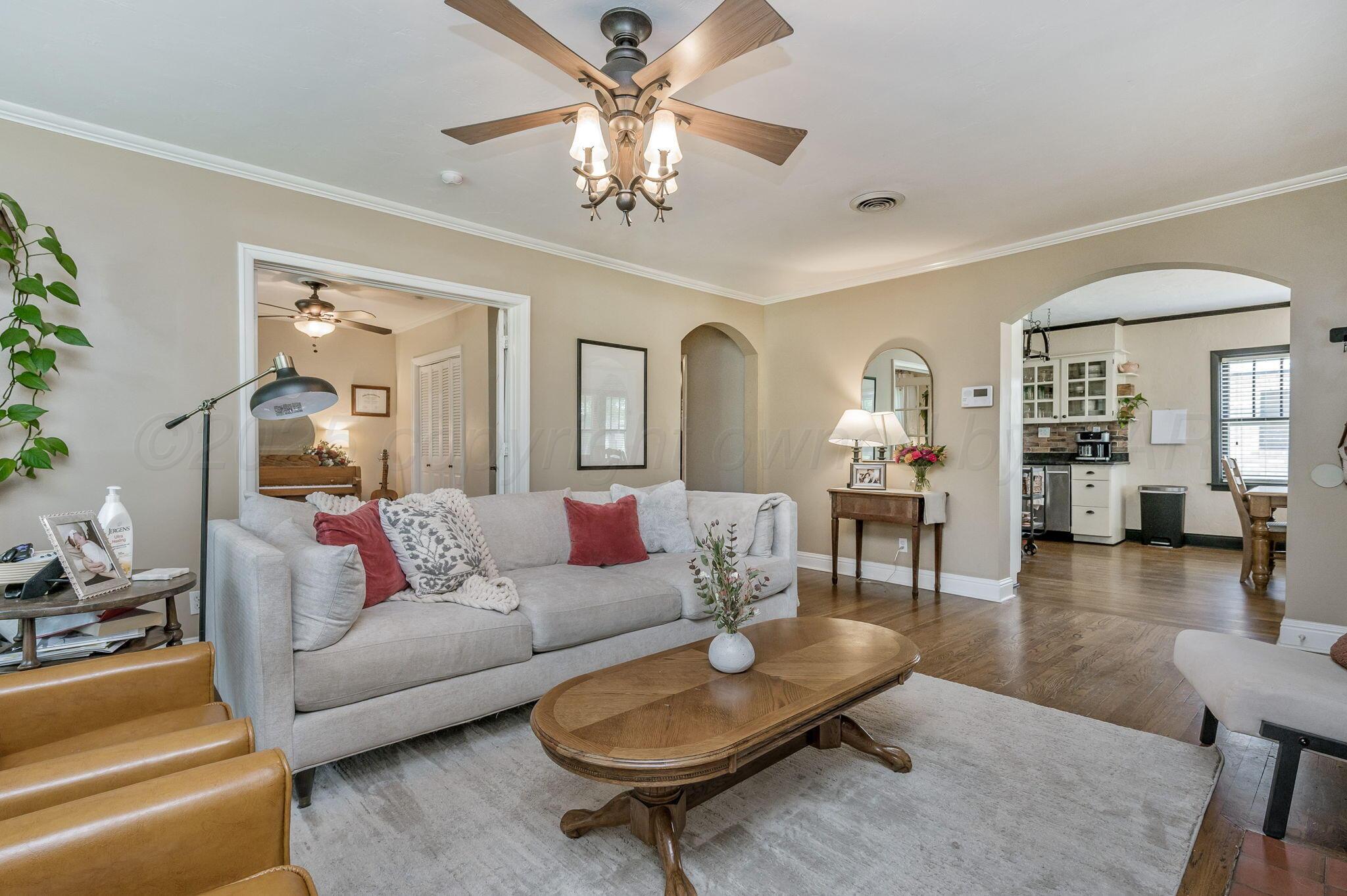 501 Sunset Terrace Amarillo, TX 79106 - Photo 5 of 21 a living room with furniture a chandelier a rug and a chandelier