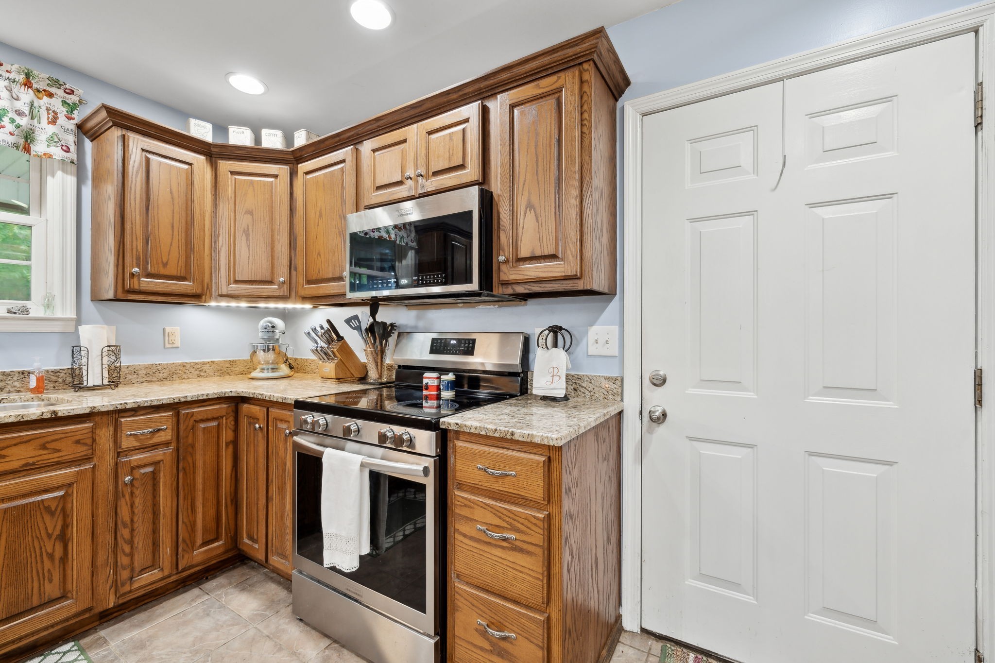 1550 Beech Bottom Road Watertown, TN 37184 - Photo 10 of 38 a kitchen with stainless steel appliances granite countertop a stove a sink and a microwave