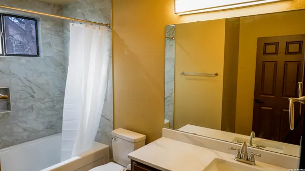 a bathroom with a shower and a window