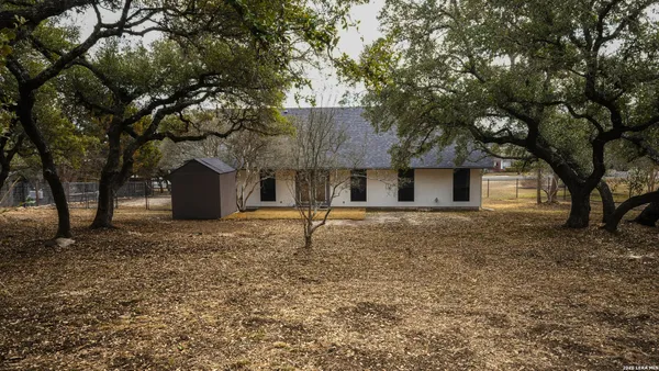 a view of a livingroom with furniture and chandelier fan