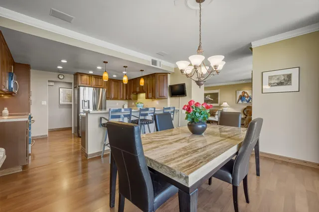 a dining room with furniture and chandelier