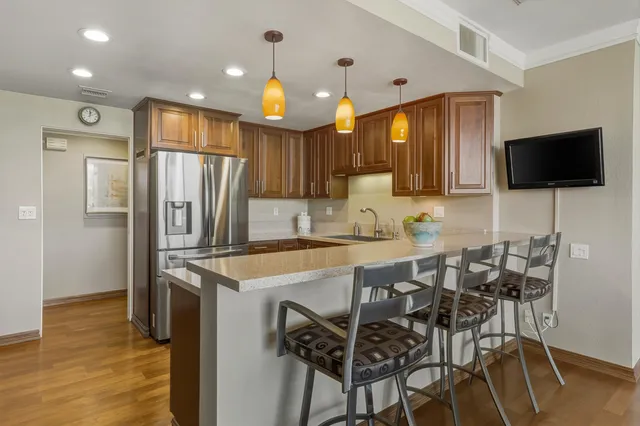 a kitchen with stainless steel appliances a refrigerator and a microwave