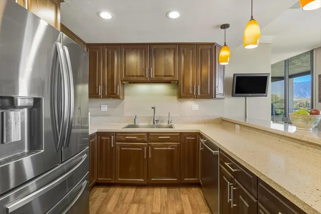 a kitchen with stainless steel appliances a sink stove and refrigerator