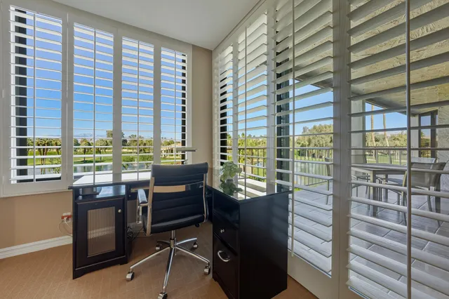 a view of a workspace with furniture and windows