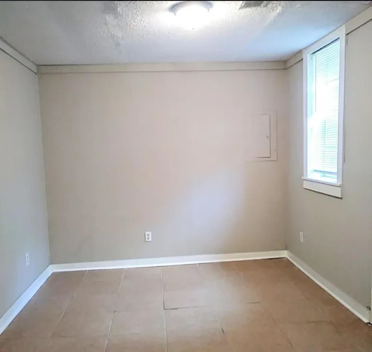 1008 Walk Road Memphis, TN 38109 - Photo 2 of 6 a view of an empty room with a window