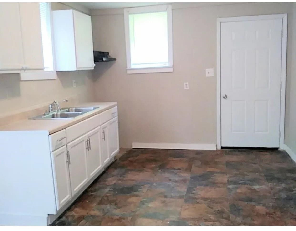 1008 Walk Road Memphis, TN 38109 - Photo 5 of 6 a kitchen with a sink cabinets and a window