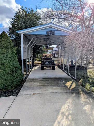 a living room with hard wood floors and a bed