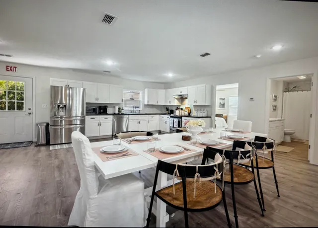 a view of a dining room with furniture and wooden floor