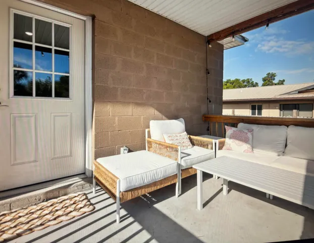 a view of a balcony with two chairs and a table