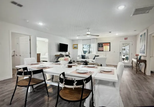 a view of a dining room with furniture and wooden floor