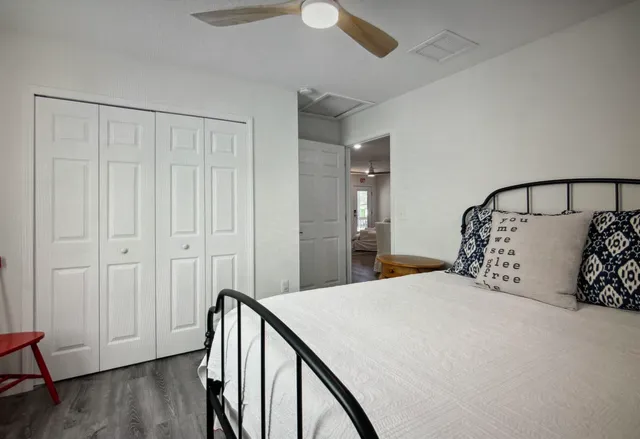 a bedroom with a bed and a table in it with window