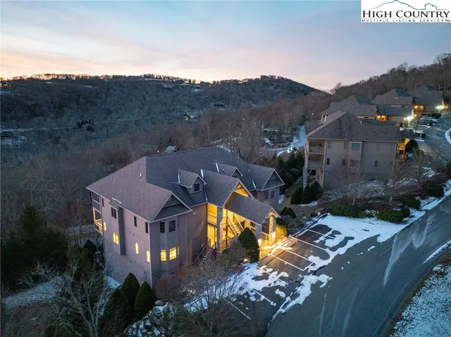 an aerial view of houses with a street