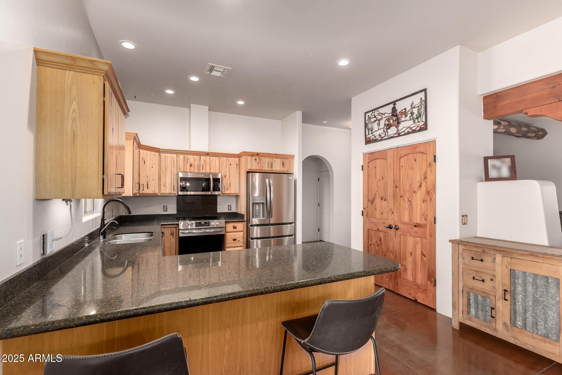 40342 North 253rd Avenue Morristown, AZ 85342 - Photo 12 of 73 a kitchen with stainless steel appliances granite countertop a refrigerator a sink a stove and white cabinets with wooden floor