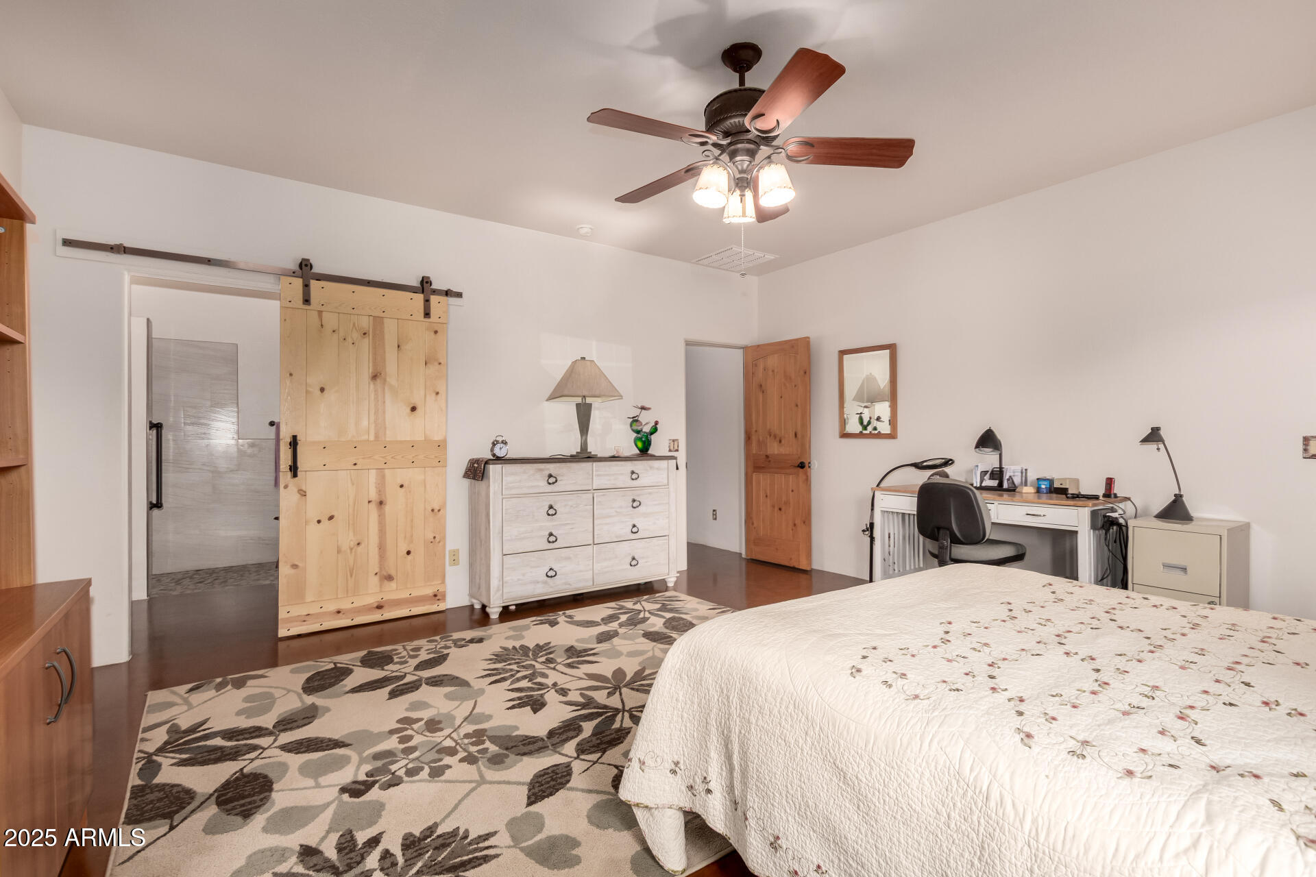 40342 North 253rd Avenue Morristown, AZ 85342 - Photo 16 of 73 a bedroom with a bed and a chandelier