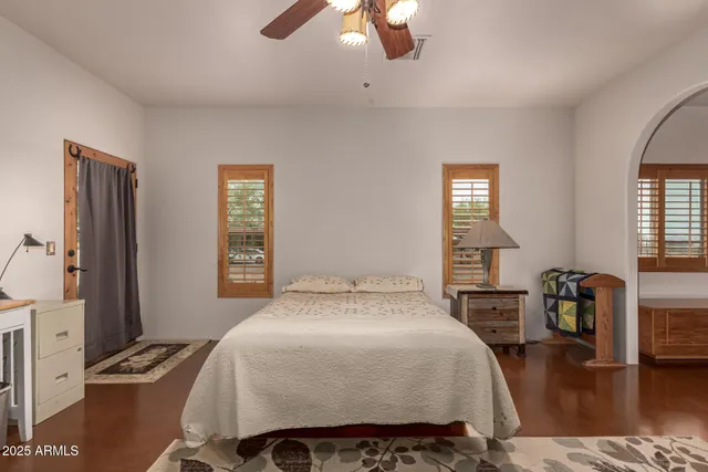 a bed sitting in a bedroom next to a window