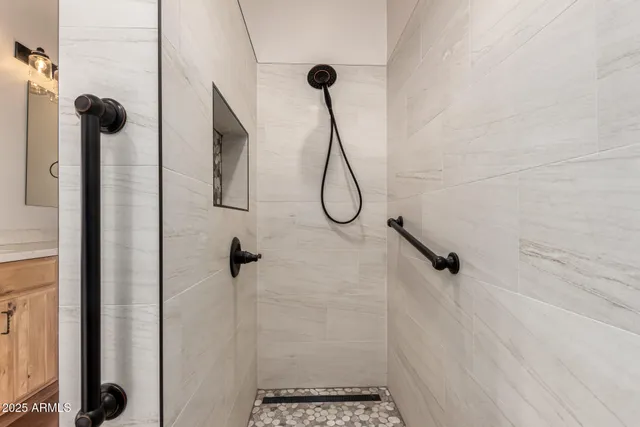 a bathroom with a granite countertop sink toilet and shower