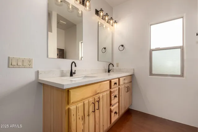 a bathroom with a sink a mirror and shower