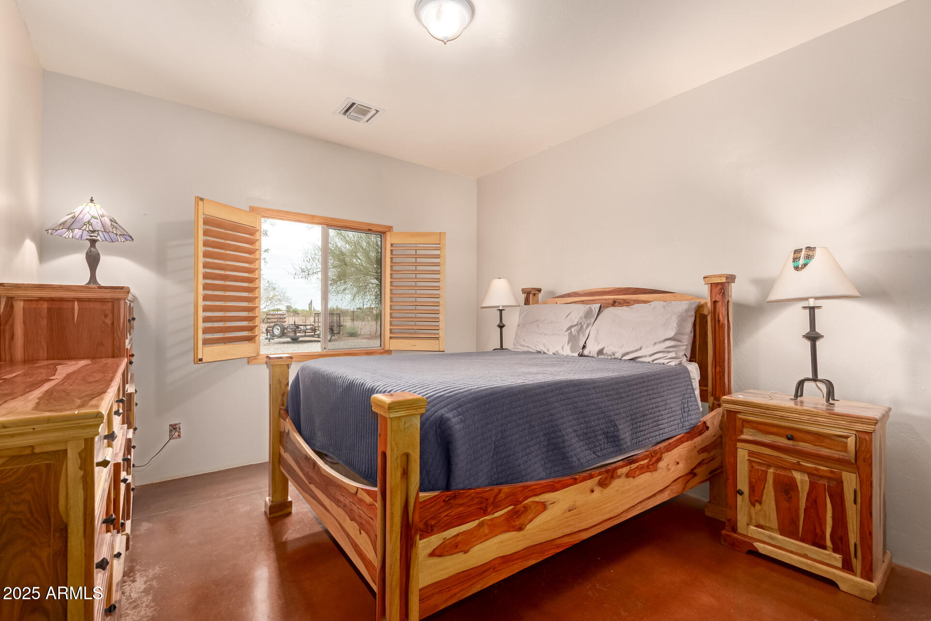 40342 North 253rd Avenue Morristown, AZ 85342 - Photo 23 of 73 a bed sitting in a bedroom next to a window