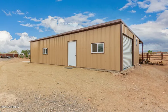 an aerial view of a house with a yard and lake view