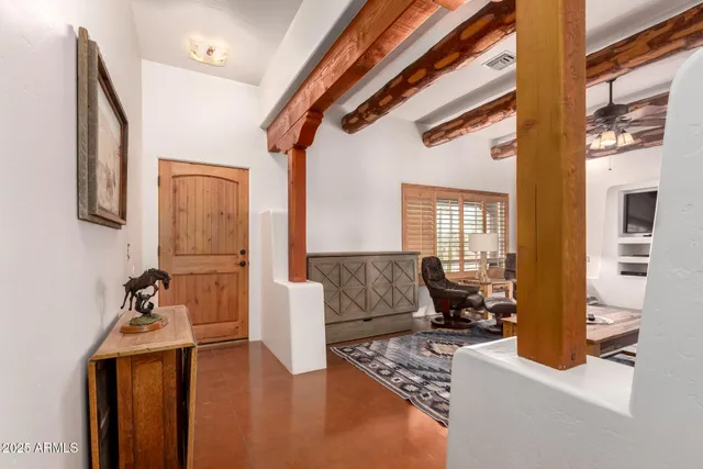 a kitchen with stainless steel appliances kitchen island granite countertop a table chairs and a refrigerator