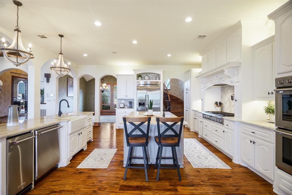 507 Chambers Point Drive Kerens, TX 75144 - Photo 14 of 39 a large kitchen with stainless steel appliances granite countertop a stove a sink dishwasher a dining table and chairs with wooden floor