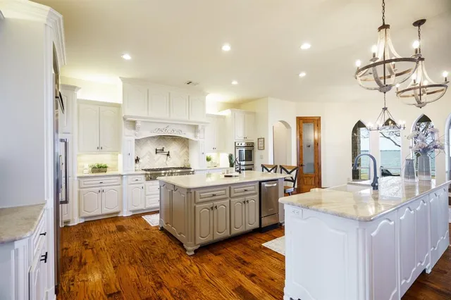 a large kitchen with cabinets a sink and appliances