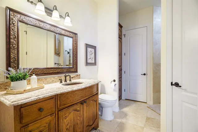 a bathroom with a granite countertop sink mirror and a