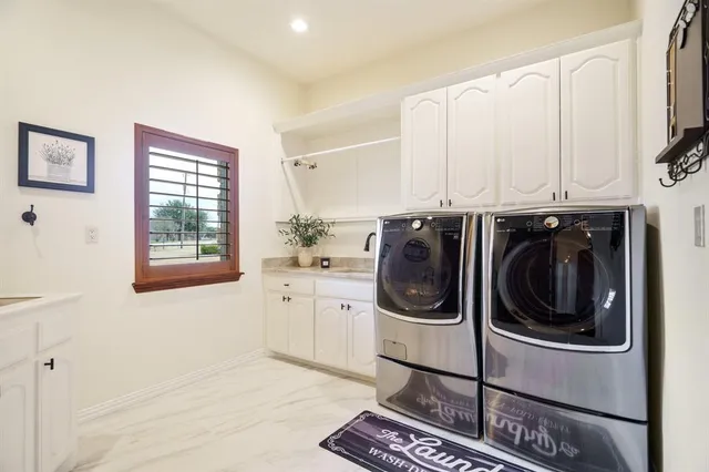 a utility room with sink dryer and washer