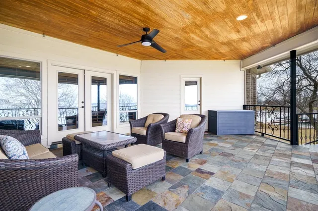 a living room with furniture a ceiling fan and a table