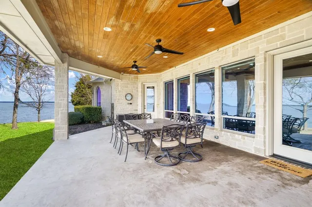 a view of a patio with table and chairs and potted plants